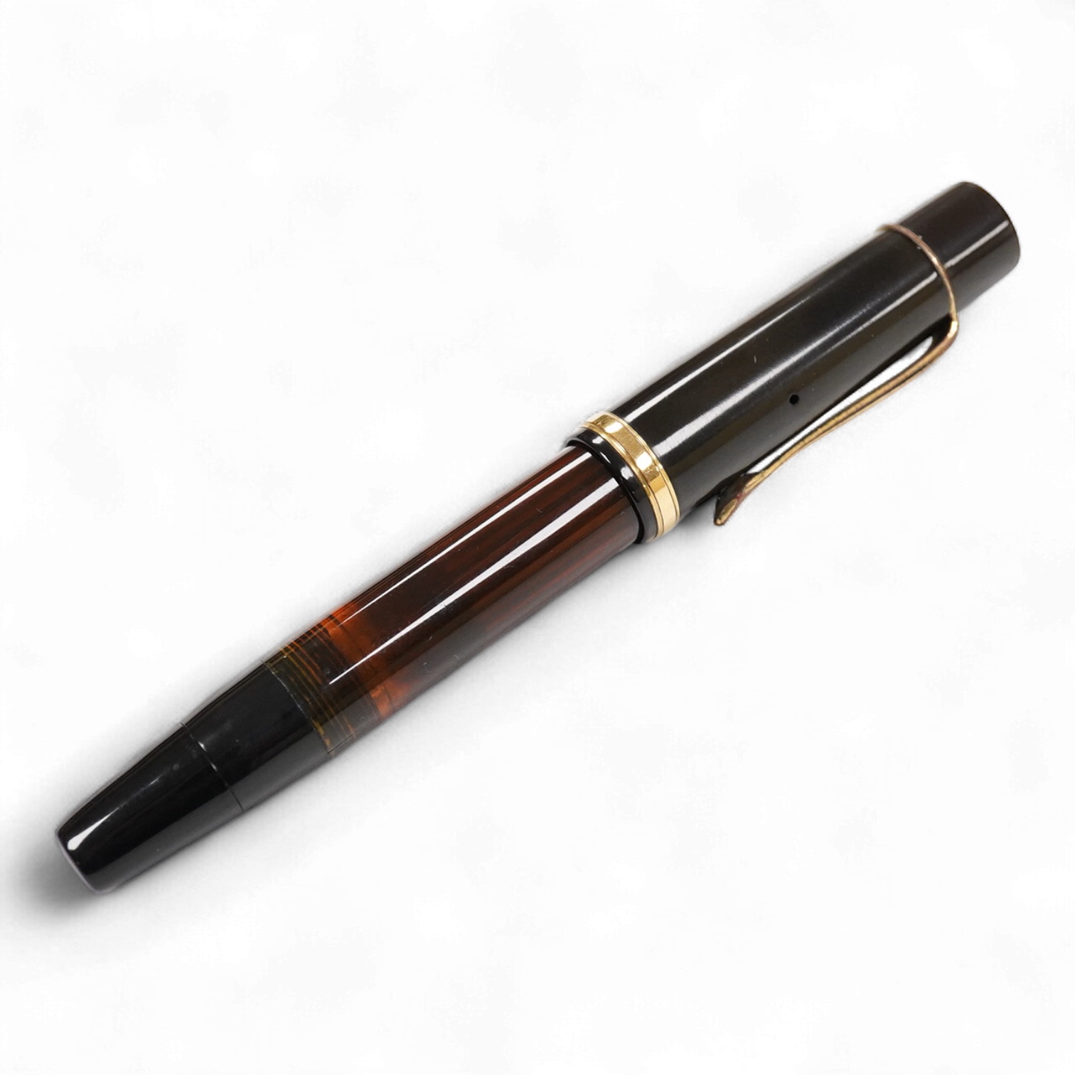 A Montblanc button fill fountain pen in brown which appears to be a 136 although worn from blind cap